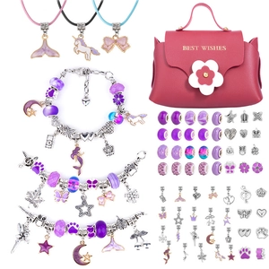 Pink handbag case with DIY jewelry kit including purple beads and unicorn charms