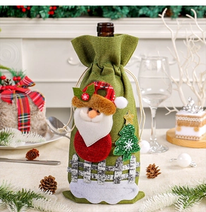 Detailed view of the Santa Claus burlap wine bottle cover within a festive Christmas scene