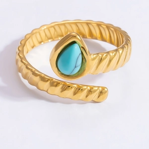 Detailed close-up of water drop turquoise stone set in a twisted gold stainless steel ring