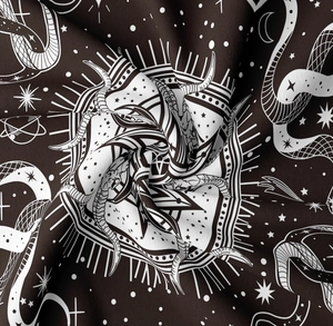 Detailed close-up of dark brown tapestry with white mystical celestial mountain prints