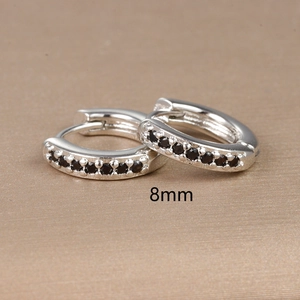 Macro view of 8mm silver hoop earrings featuring black cubic zirconia inlay details