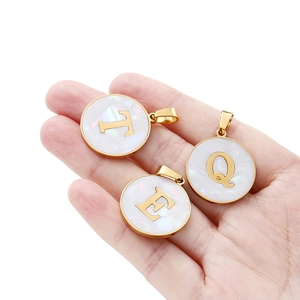 Round stainless steel alphabet pendants with gold plating and white mother of pearl