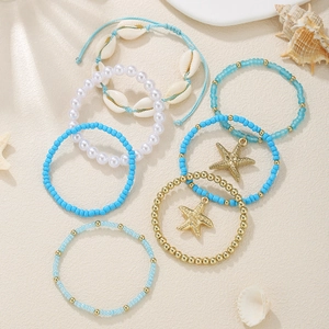 Detailed arrangement of blue and gold seaside shell starfish beaded bracelet set