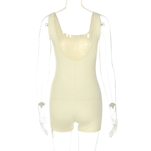 Detail view of the deep backless design and textured beige fabric of the bodycon romper