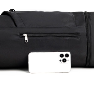 Detail of yoga mat bag with a zipper pocket showing size comparison to a smartphone