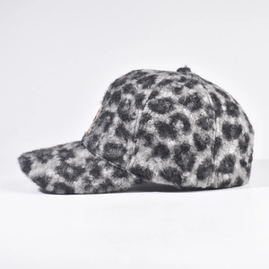 Detailed side view showing leopard print lamb wool texture on the baseball cap