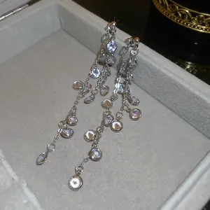 Silver long tassel drop earrings with sparkling round cubic zirconia in a jewelry box