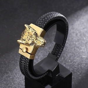 Detailed view of wolf head clasp and black braided leather cord on men's bracelet