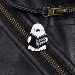 Detailed close-up of ghost reading Human Stories book enamel pin on black leather jacket