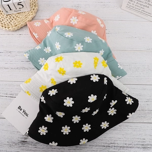 Reversible daisy bucket hat in four colors including pink, green, white and black