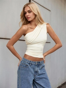 Detail of ivory one-shoulder top showing slim fit cut and side ruching texture