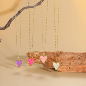 Dainty gold heart pendant necklaces in purple pink and white enamel with vintage details