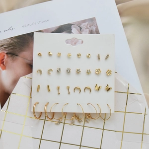 Golden 12-pair earring set with geometric shapes and crystal studs on display card