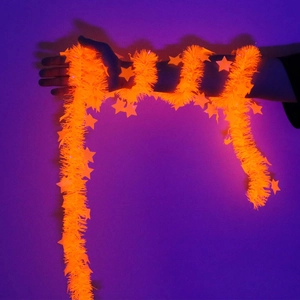 Close-up of 2m neon orange star tinsel garland showing UV glow effect for party decor