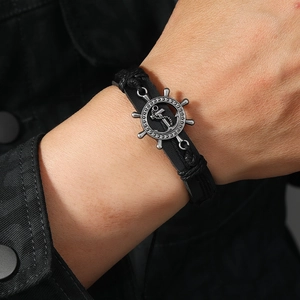 Men's black leather woven bracelet featuring vintage silver helm and anchor charms