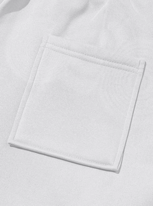 Close-up of high-quality white fleece fabric and detailed pocket stitching on sweatpants