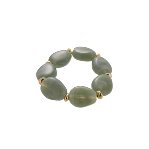 Irregular acrylic oval green beaded bracelet with gold metal spacers on white background
