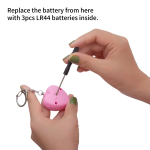 Detailed view of the heart alarm showing the 3pcs LR44 battery replacement process