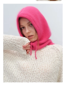 Detail of bright pink knitted balaclava with drawstring and cozy ribbed texture