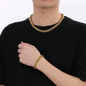 Polished gold basket weave link necklace and bracelet set for men on a black shirt