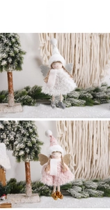 Close-up of white and pink plush angel ornaments with glittery wings for Christmas decor
