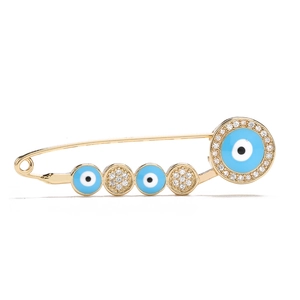 Detailed view of an 18K gold-plated evil eye safety pin brooch with sparkling zircons