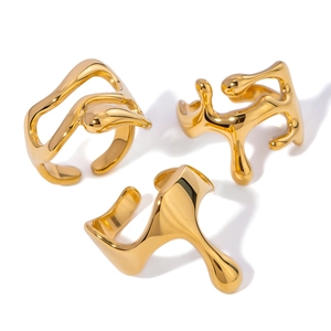 Three gold irregular fluid style stainless steel open rings shown on a white background