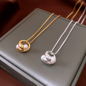 Detail of 18k gold and silver plated necklaces with organic pendants and pearls