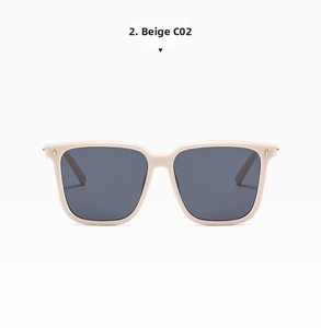 Detail view of beige oversized square sunglasses with gold metal hinges and grey lenses