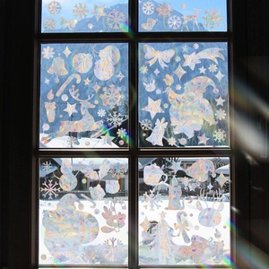 Close-up of holographic Christmas reindeer window stickers with rainbow prism effects