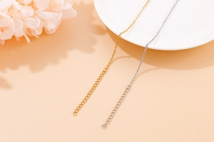 Macro detail of gold and silver stainless steel heart necklace extension chains