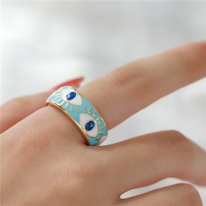 Detailed macro view of 18K gold plated evil eye open ring with blue enamel drip oil