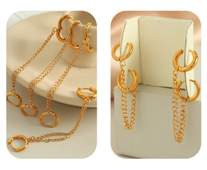 Detail of gold-plated circular hoop earrings with connected chain in 18K finish