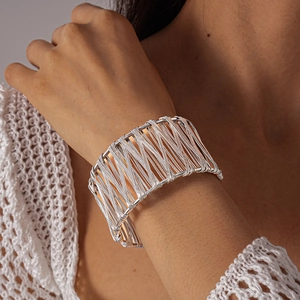 Polished silver metal hollow woven open cuff bracelet in a geometric interlaced design