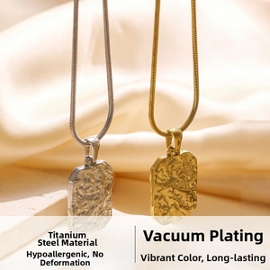 Detail of gold and silver rectangular titanium steel pendants with hammered texture finish