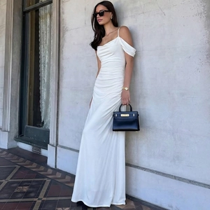 Detail of white slim-fit maxi dress featuring side ruching and elegant backless design