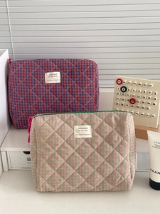 Quilted checkerboard cosmetic bags in red-blue and pink-green patterns with tassels