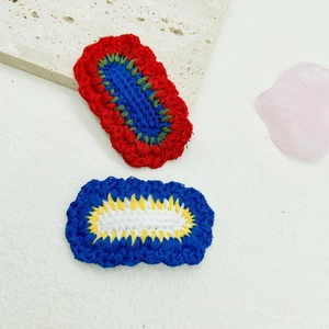 Detail of colorful handmade crochet heart patches for DIY hair accessories and clips