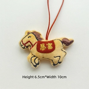 Detail of yellow plush horse charm with red Gongxi embroidery, 10cm x 6.5cm size details