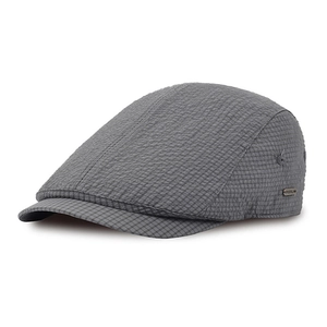 Close-up of gray checkered seersucker newsboy cap with antique bronze metal logo detail