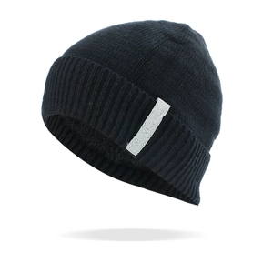 Detailed close-up of a black knit beanie with a stylish side rectangle patch decoration