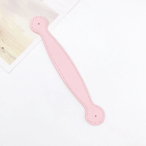 Detailed macro view of pink cross-grain leather strap with fine stitching and round hole punch