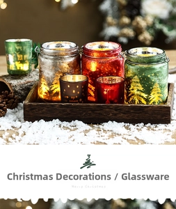Christmas themed frosted glass candle holders with metal handles and pine cone decor