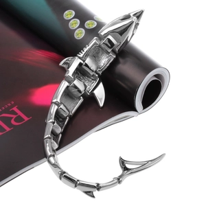 Close-up of a silver shark bracelet with mechanical movable joints on a magazine