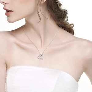 Elegant heart-shaped MOM necklace with crystals on female model for Mother's Day gift