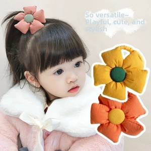 Detail of fabric flower hair ties showing soft cotton texture and colorful floral designs