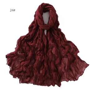 Detailed view of dark burgundy pleated scarf featuring soft crinkle texture and wavy edges