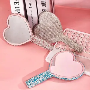 Sparkling heart-shaped handheld makeup mirrors in silver, pink, and blue rhinestone designs