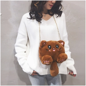 Detail of the brown plush cat bag showing soft fur texture and golden metal chain strap