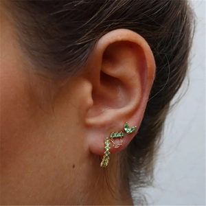 Detailed close-up of bohemian gold ear cuff set with green marquise crystals